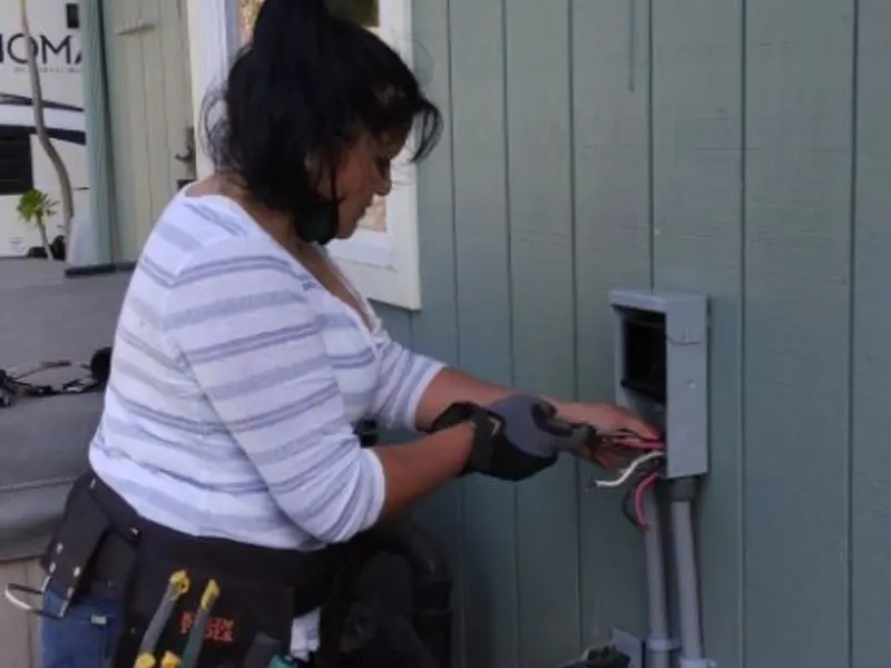 Licensed electrician wiring an exterior subpanel in Ithaca
